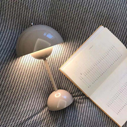 Small lamp next to an open book on a textured surface