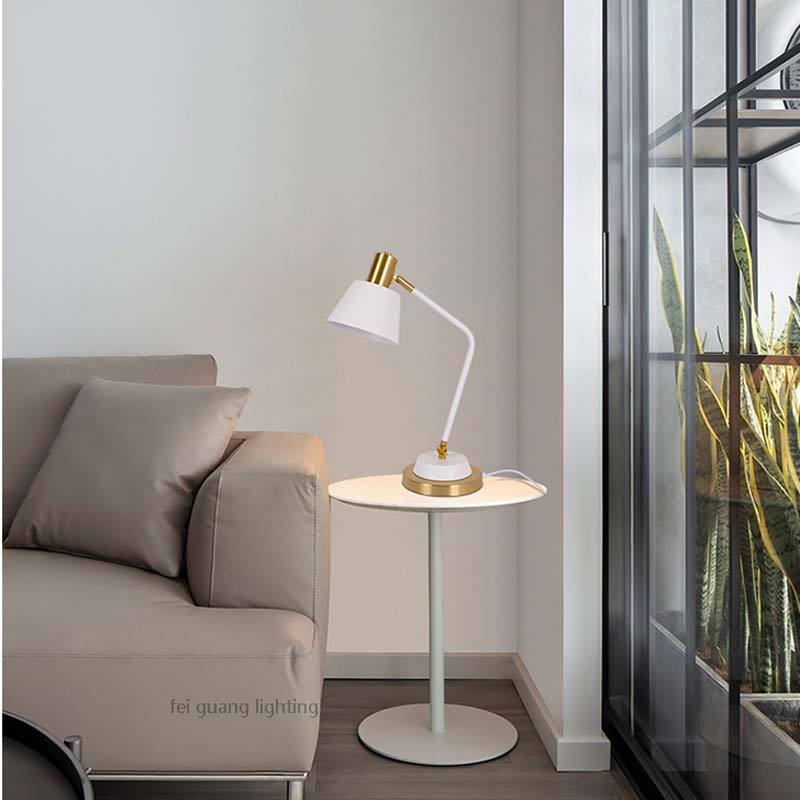 The Modern Adjustable LED Reading Desk Lamp sits on a small round side table next to a beige sofa in a minimalist interior.