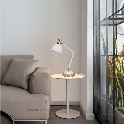The Modern Adjustable LED Reading Desk Lamp sits on a small round side table next to a beige sofa in a minimalist interior.
