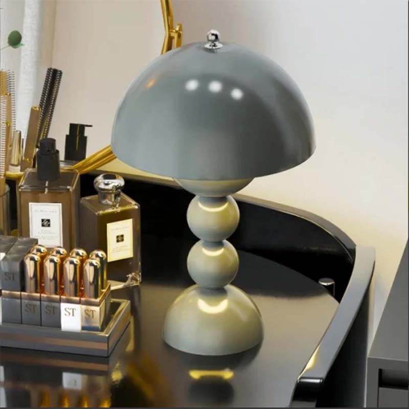 Gray table lamp on a desk with decorative items