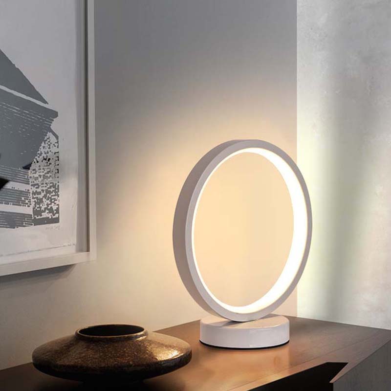 Minimalist LED ring desk lamp on table, modern interior lighting, soft diffused light for home office or bedroom decor