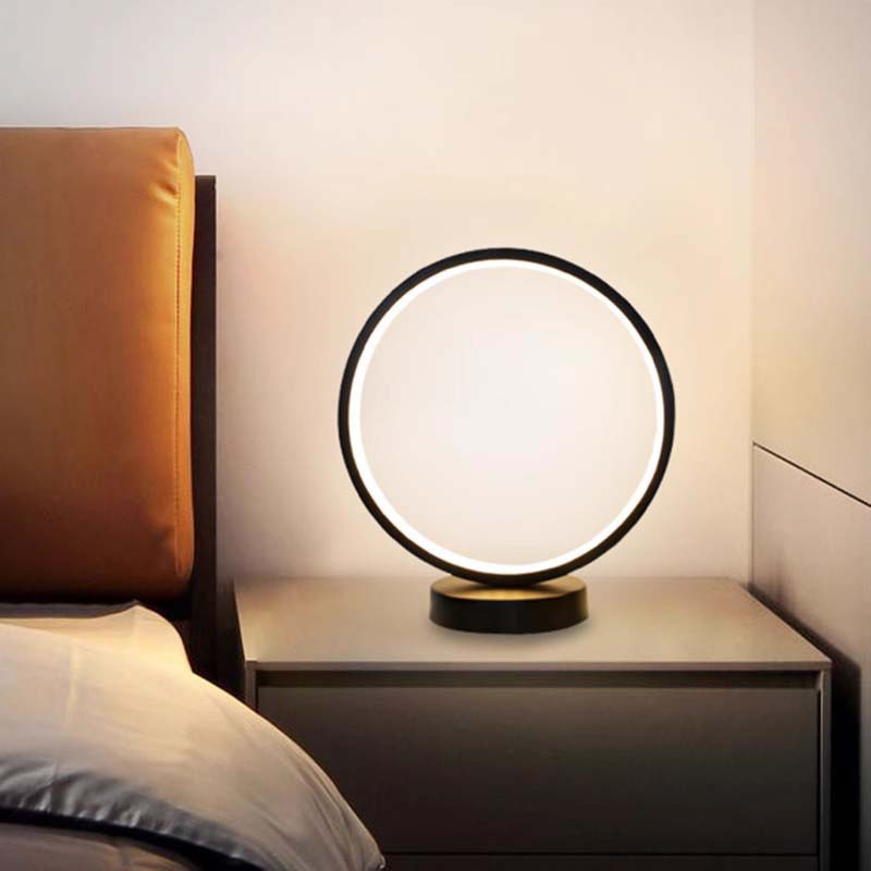 Minimalist LED ring table lamp on nightstand, modern bedside lighting for bedroom decor