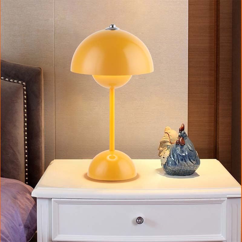 Yellow table lamp on a nightstand with decorative items