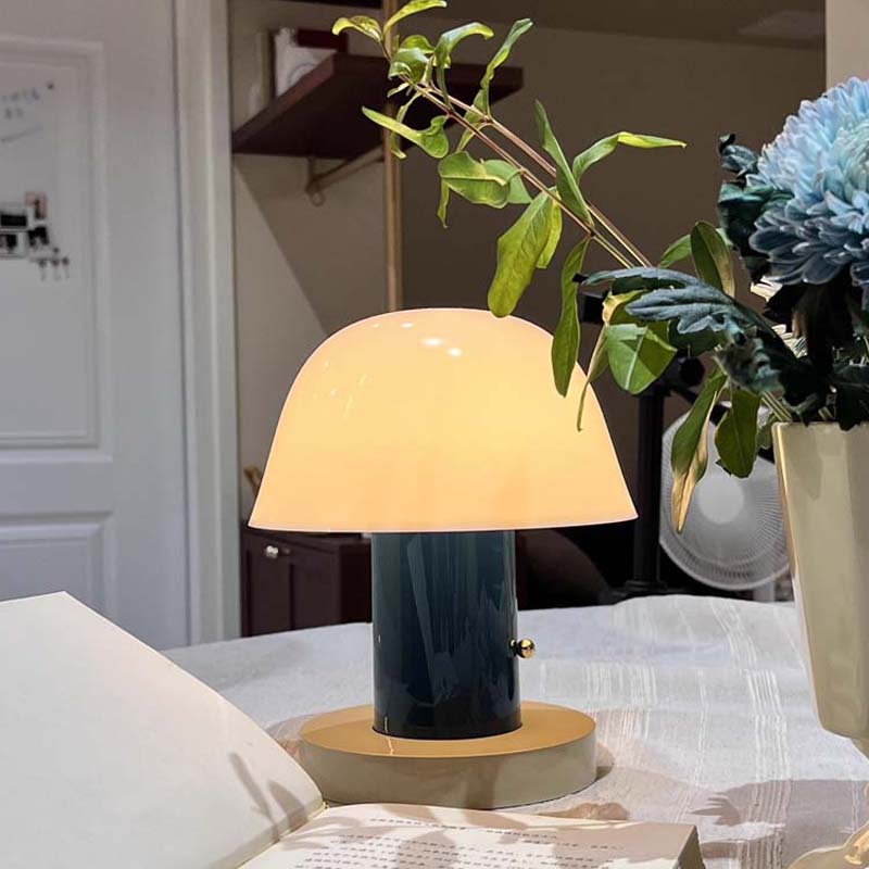 Nordic Mushroom LED Table Lamp stands on a table with flowers in a real interior.