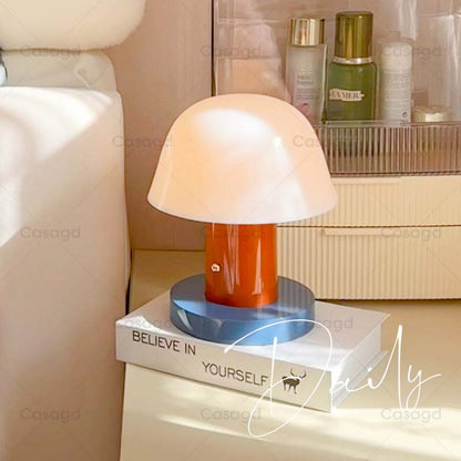 Nordic Mushroom LED Table Lamp sits on a white book on the bedside table.