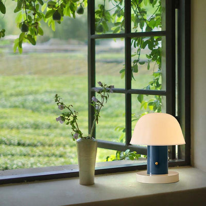 There is a Nordic Mushroom LED Table Lamp and a vase of flowers on the windowsill