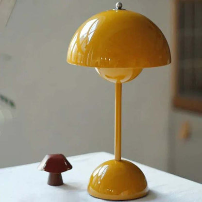 Yellow mushroom-shaped lamp on a white surface with a neutral background