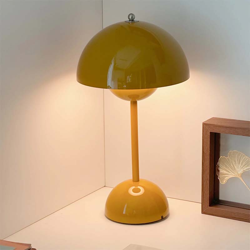 Yellow table lamp on a white surface with a neutral background