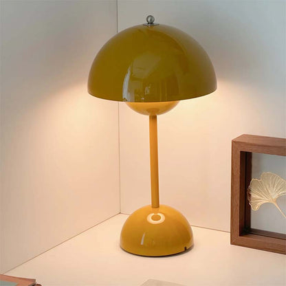 Yellow table lamp on a white surface with a neutral background