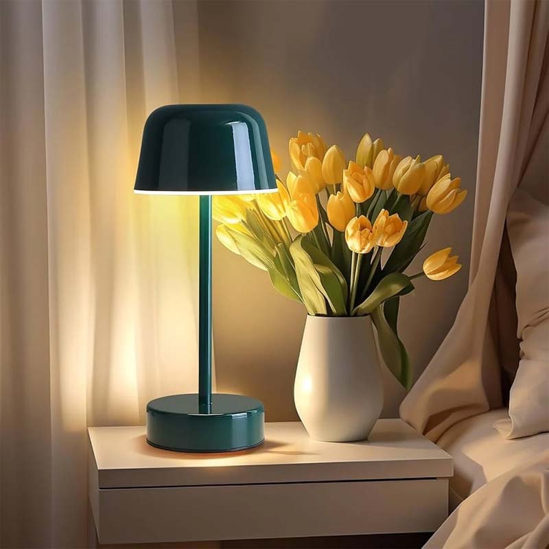 A green Rechargeable Cordless Touch LED Table Lamp and a white vase with yellow tulips on the nightstand.