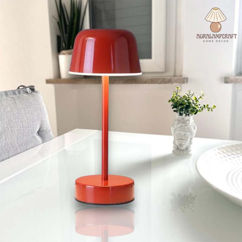 A red Rechargeable Cordless Touch LED Table Lamp sits on a white tabletop in a stylish interior.