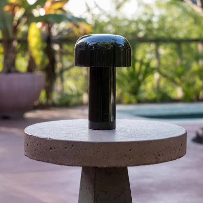Rechargeable Mushroom LED Table Lamp stands on an outdoor terrace
