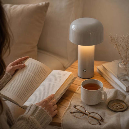 Rechargeable Mushroom LED Table Lamp sits on a wooden side table in a cozy living room setting
