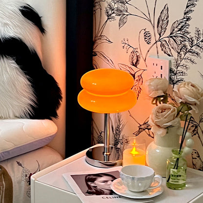 Retro Sandwich Glass Table Lamp placed on a white nightstand next to a mug, candle and floral decor.