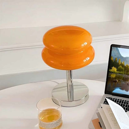 Retro Sandwich Glass Table Lamp sits on a white table next to a laptop and a glass of amber liquid