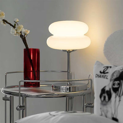 Retro Sandwich Glass Table Lamp placed on a matching chrome side table next to a red vase with white flowers.