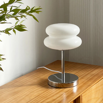 Retro Sandwich Glass Table Lamp placed on a wooden sideboard next to a green plant.