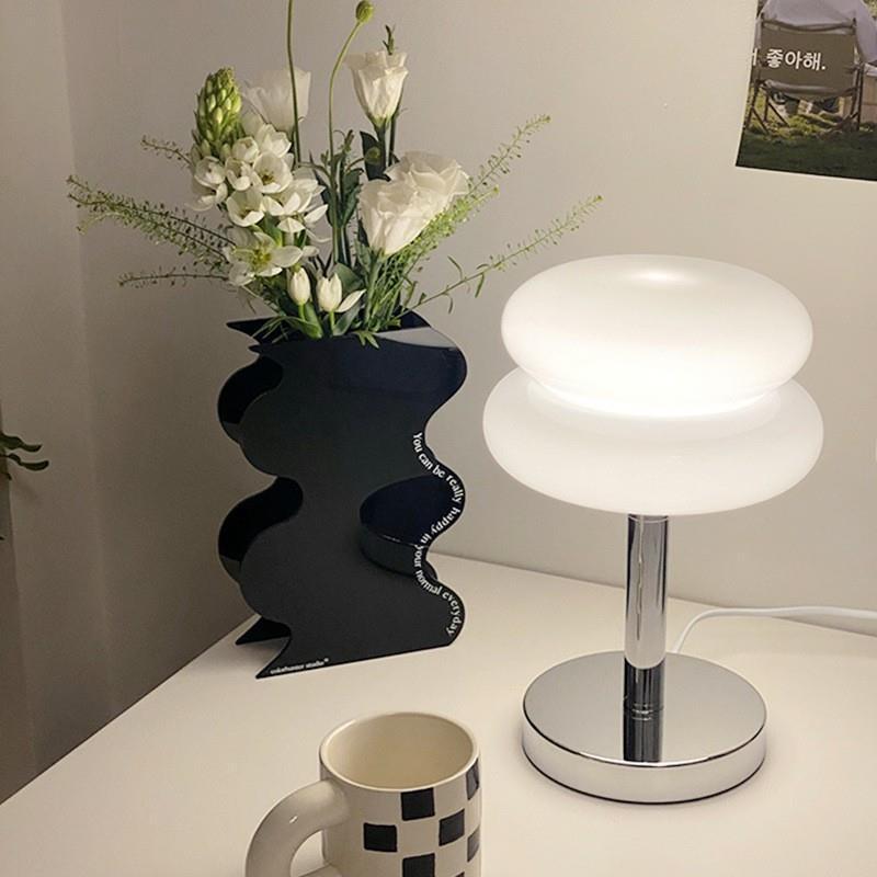 Retro Sandwich Glass Table Lamp with Flower Vase and Mug on White Surface.