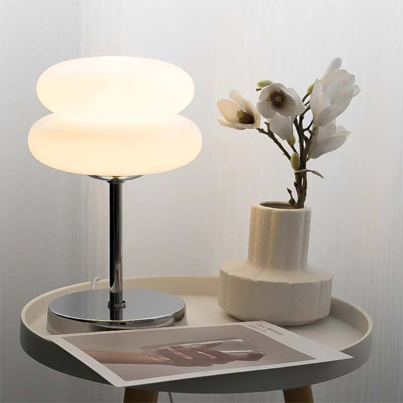 Modern side table with Retro Sandwich Glass Table Lamp, vase and flowers on neutral background.