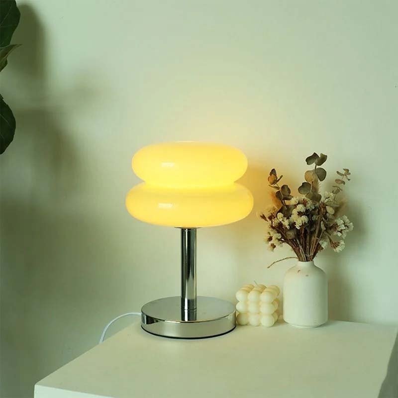 Retro Sandwich Glass Table Lamp, next to a vase of flowers and decorative items.