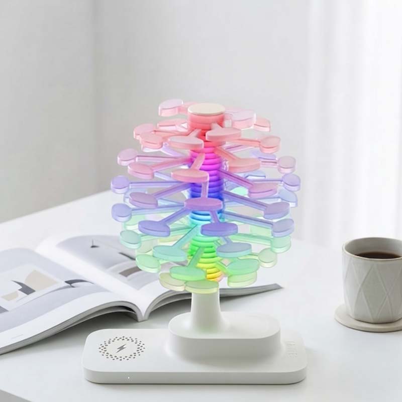 Spiral Tree LED Desk Lamp, styled to resemble a white table next to an open book and a cup of coffee.