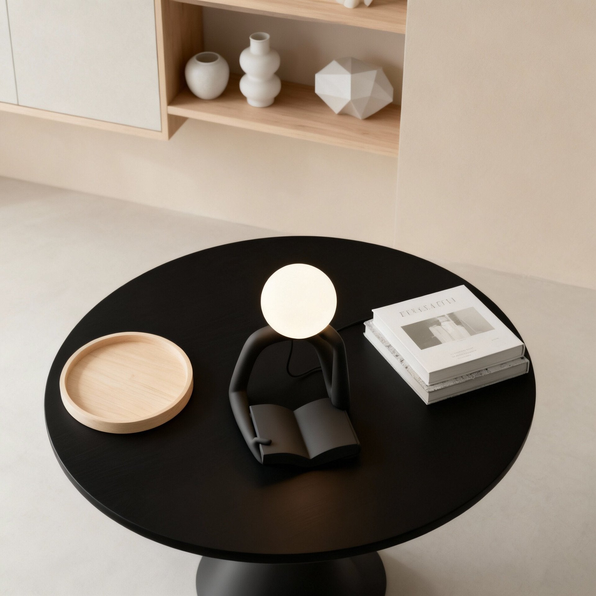 Thinker Statue LED Table Lamp, sits on a round black table