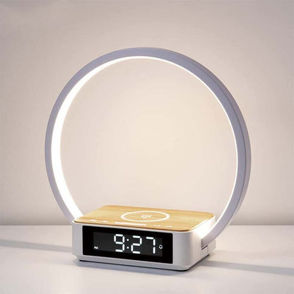 Modern table lamp with digital clock and wireless charging pad on a neutral background