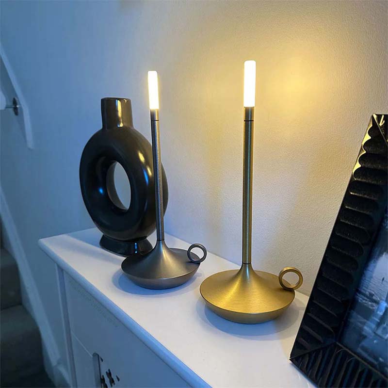 Two decorative lamps on a white surface with a neutral background