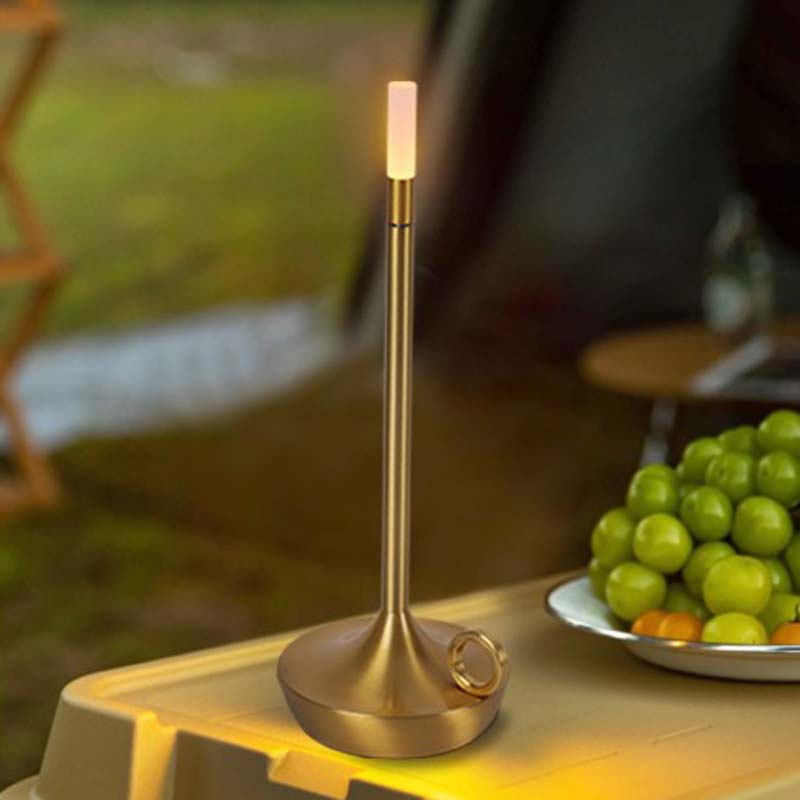 Gold Touch-Sensitive Candle Lamp on a Table with Grapes in the Background