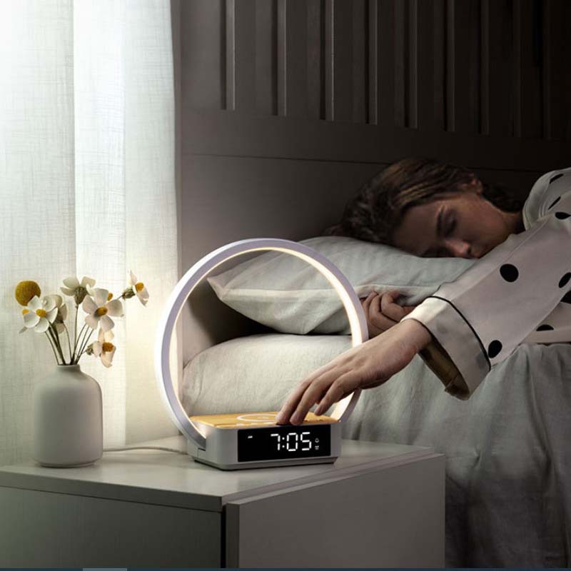 Person waking up to a digital alarm clock on a nightstand with a softly lit room.