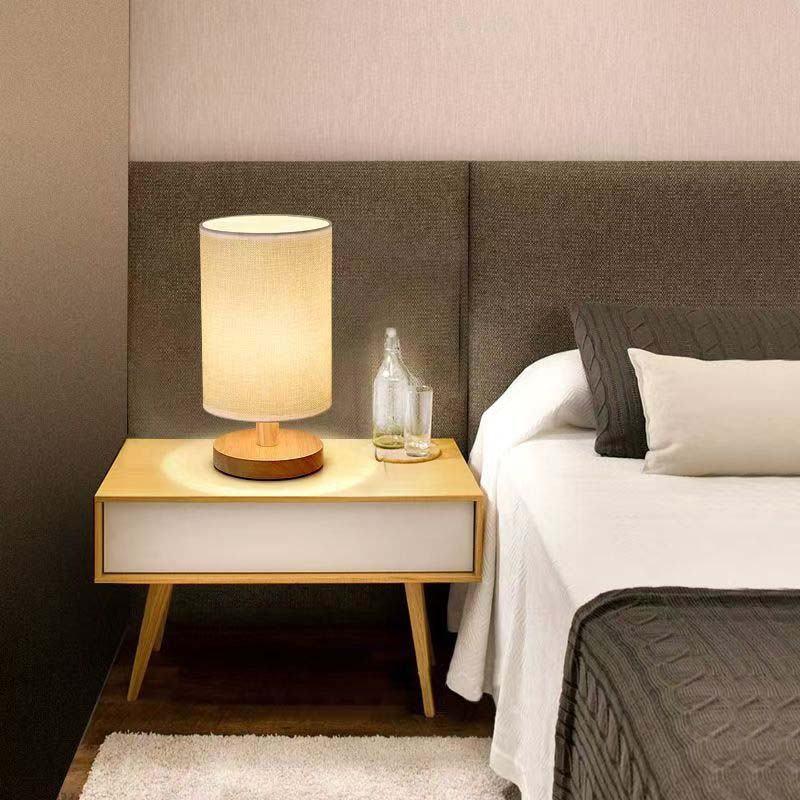 Wood Table Lamp with Natural Fabric Shade on the bedside table in the bedroom
