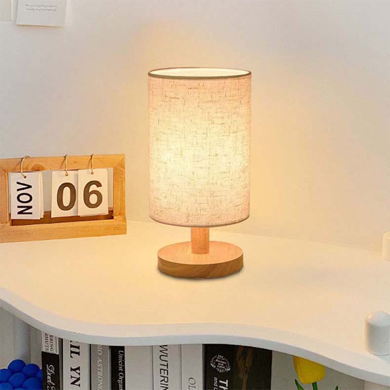 Wood Table Lamp with Natural Fabric Shade on a light designer table