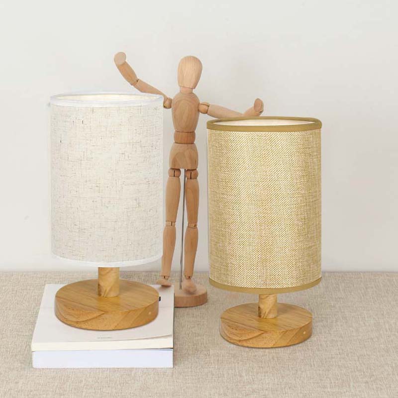 Two Wood Table Lamps with Natural Fabric Shade on a Table with a Figurine for Interior Decor